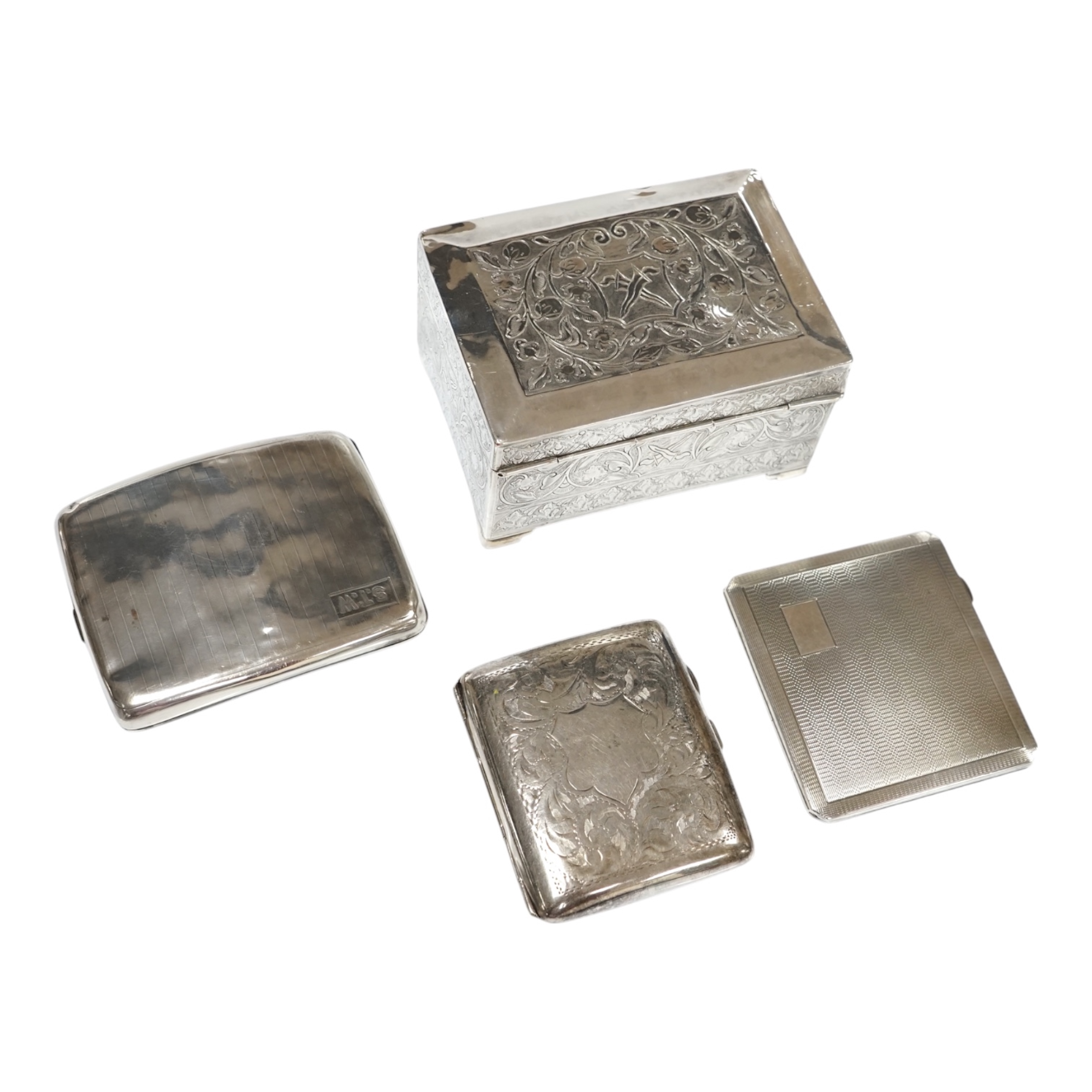 Two silver cigarette cases, a silver plated cigarette case and a Thai? white metal cigarette box, 11.6cm. Condition - poor to fair